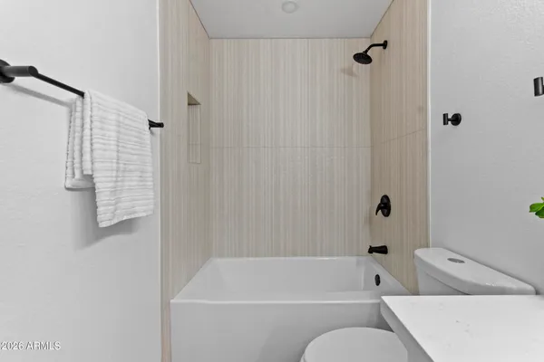 a white house with a large tree in front of it