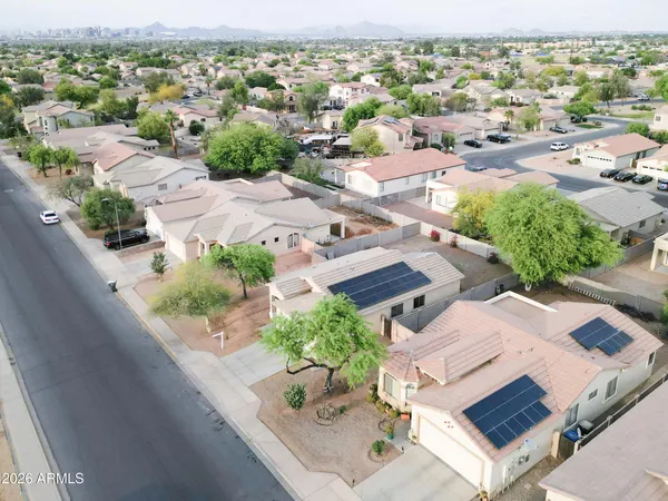 an aerial view of a house with a yard