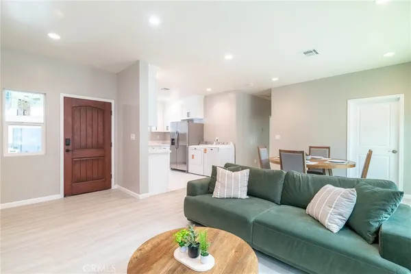 a kitchen with cabinets appliances a sink and a counter top space