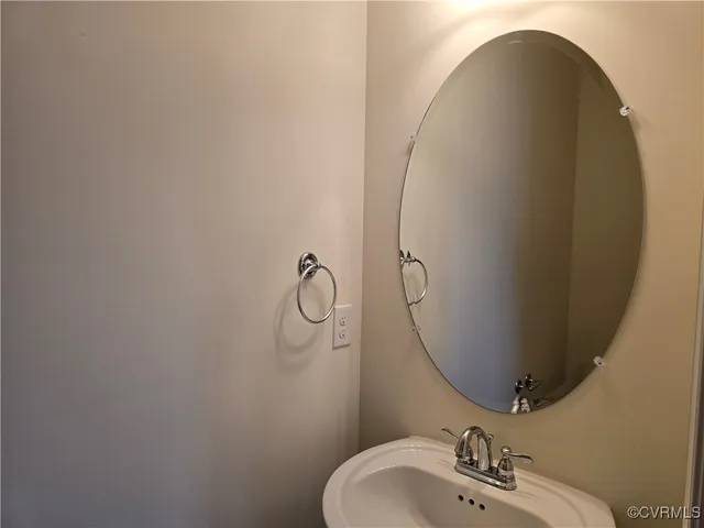 a bathroom with a sink and mirror