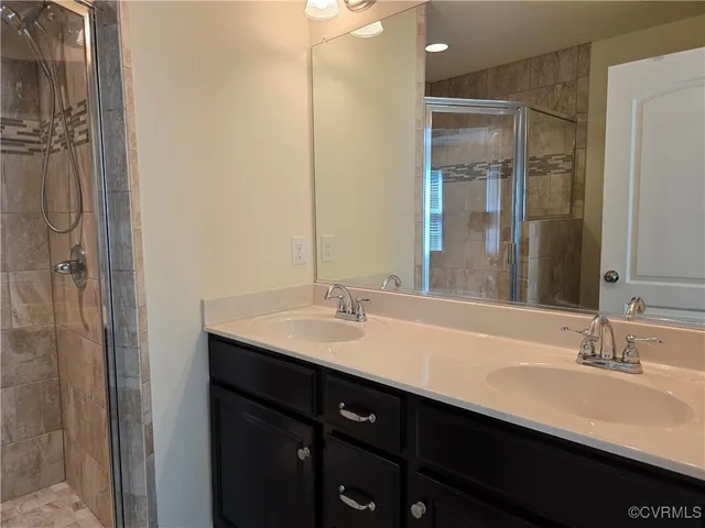 a bathroom with a double vanity sink a and mirror