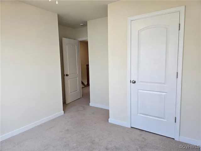 a view of an empty room and closet area