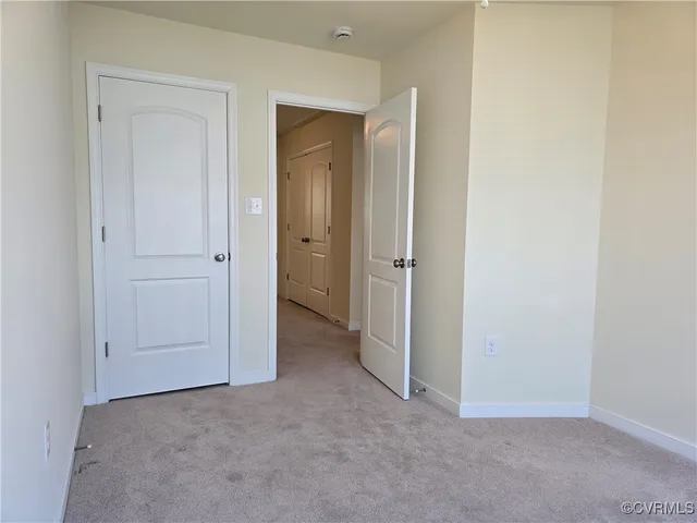 an empty room with closet area
