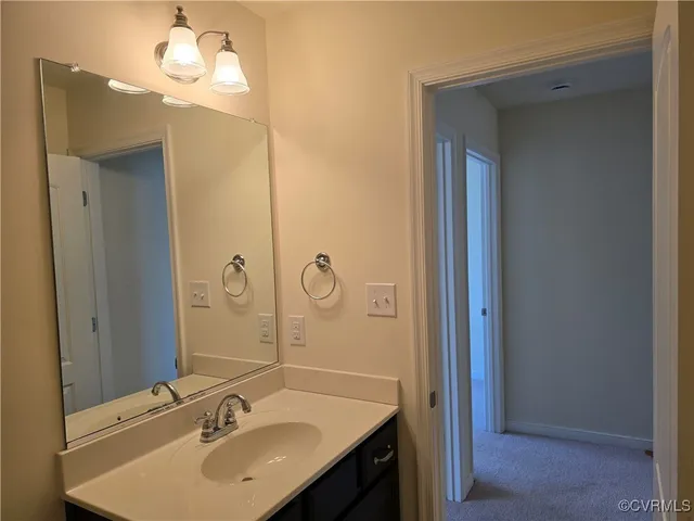 a bathroom with a sink vanity and a mirror