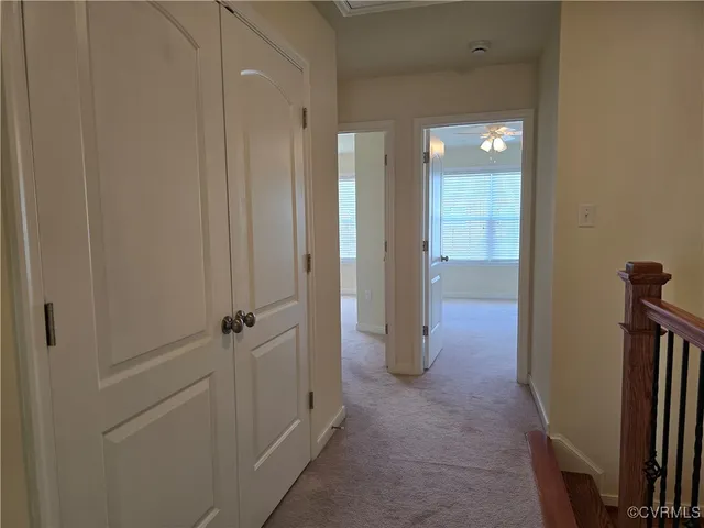 a view of a hallway with closet and wooden floor