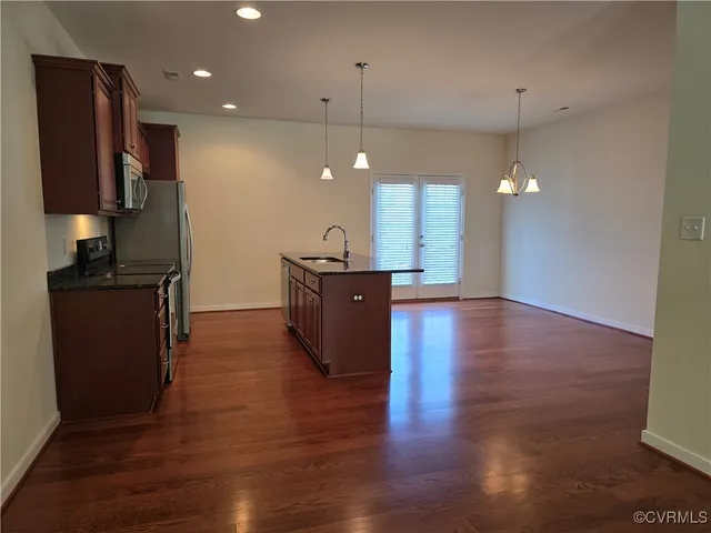 a view of a kitchen with a sink and a refrigerator