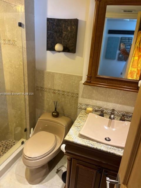 6767 Collins Avenue, Unit 1107 Miami Beach, FL 33141 - Photo 4 of 10 a bathroom with a sink a toilet and shower