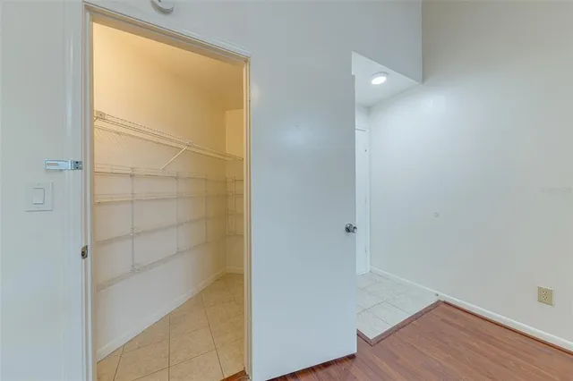 an empty room with wooden floor and a window