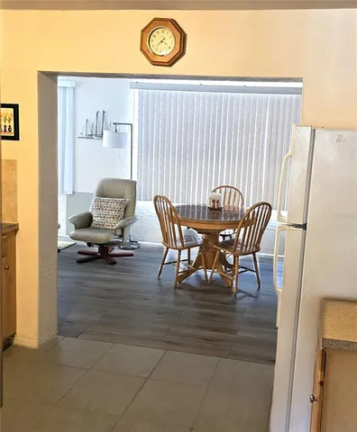 a view of a dining room with furniture and a chandelier
