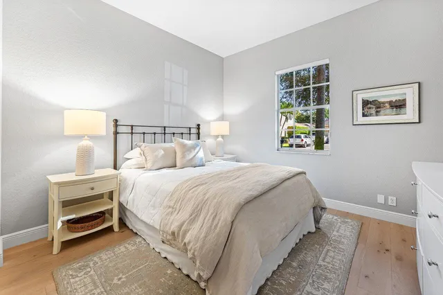 a bedroom with a bed and a night stand