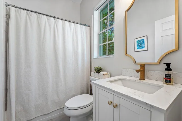 a spacious bedroom with a bed and a lamp