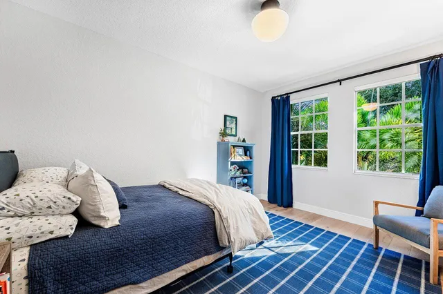 a bedroom with a bed and with furniture