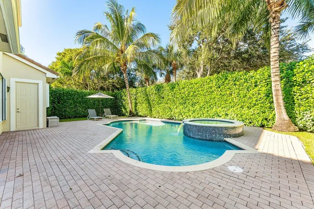 an aerial view of a house with a yard and trees