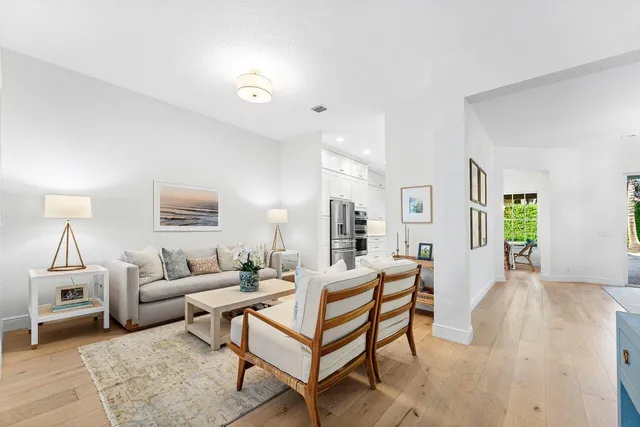 a living room with furniture a rug and a window