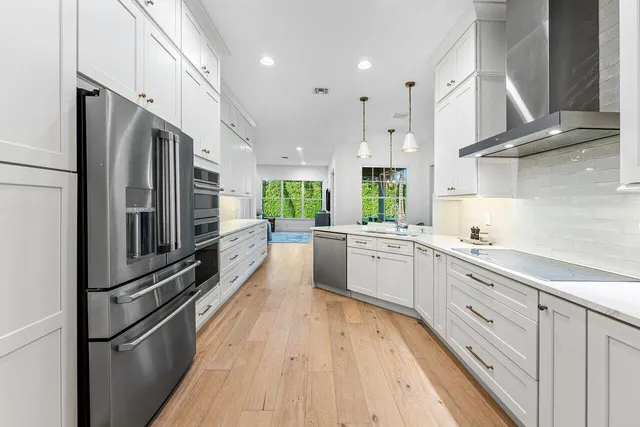 a kitchen with stainless steel appliances a refrigerator sink and stove