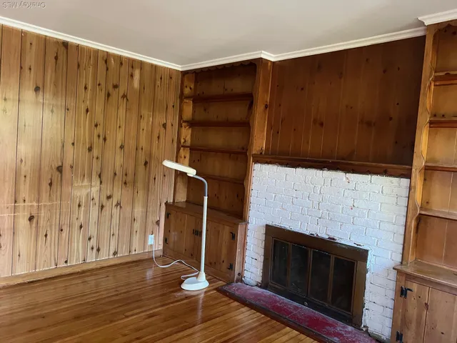 a living room with a fireplace furniture and a wooden floor