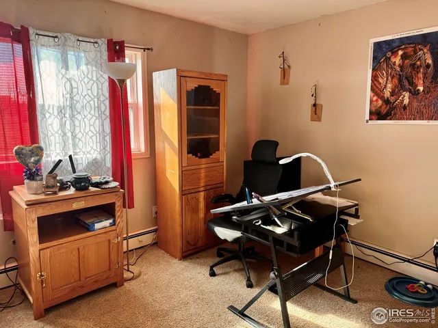 a view of a workspace with furniture and gym equipment