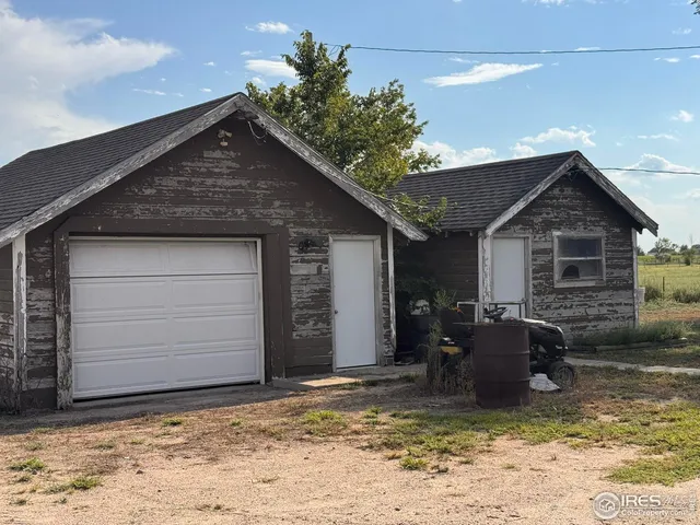 a backyard of a house with yard and garage