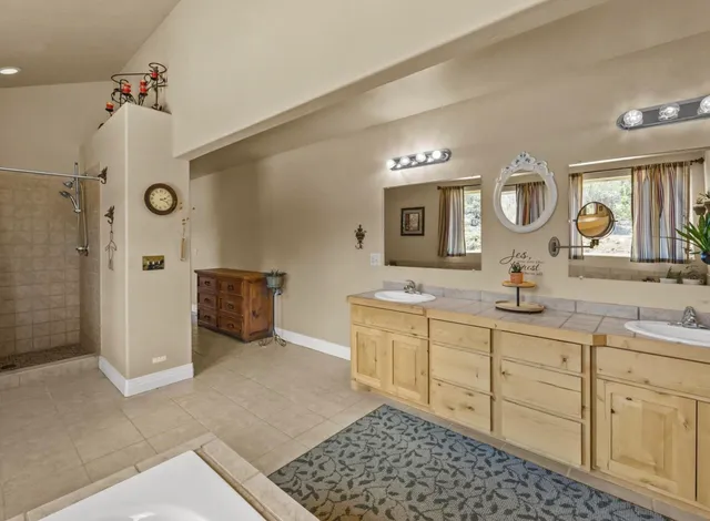 a spacious bathroom with a double vanity sink mirror and