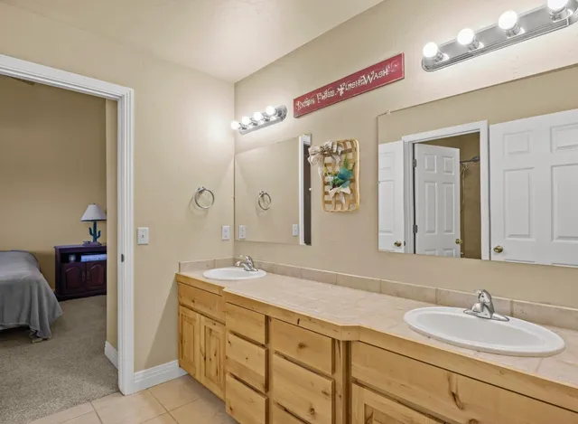 a bathroom with a sink double vanity and a mirror