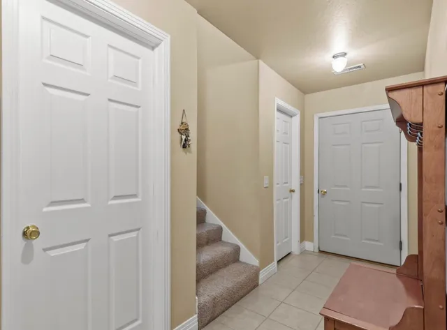 a view of entryway with white walls and stairs
