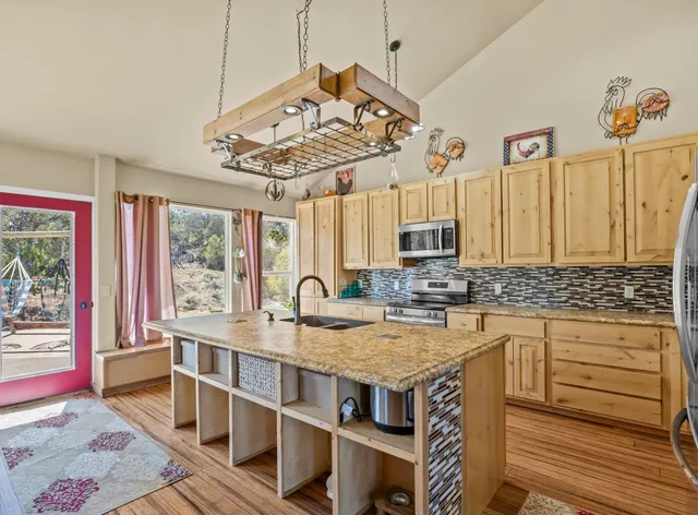 a kitchen with a stove a sink and a refrigerator