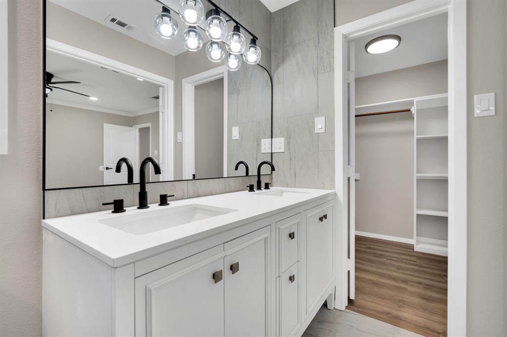 221 North Edgefield Road Waxahachie, TX 75165 - Photo 15 of 27 a bathroom with a double vanity sink and a mirror