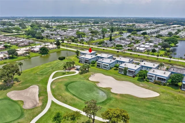 an aerial view of residential houses with outdoor space and swimming pool