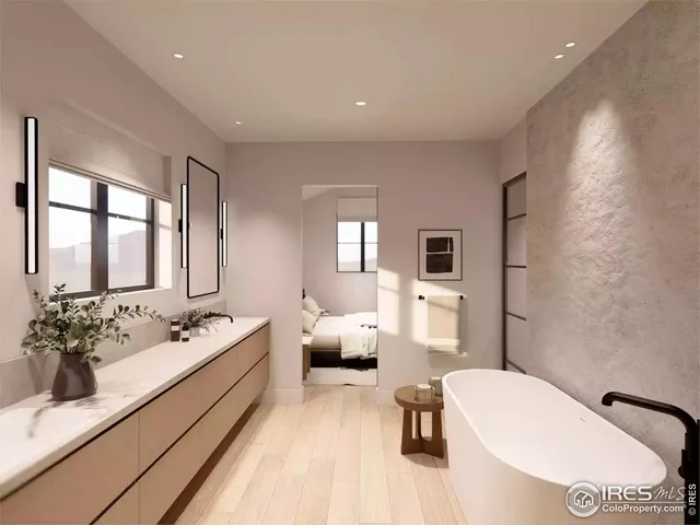 a en suite bathroom with a couch mirror and window