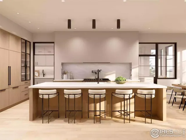 a kitchen with a sink a stove and chairs