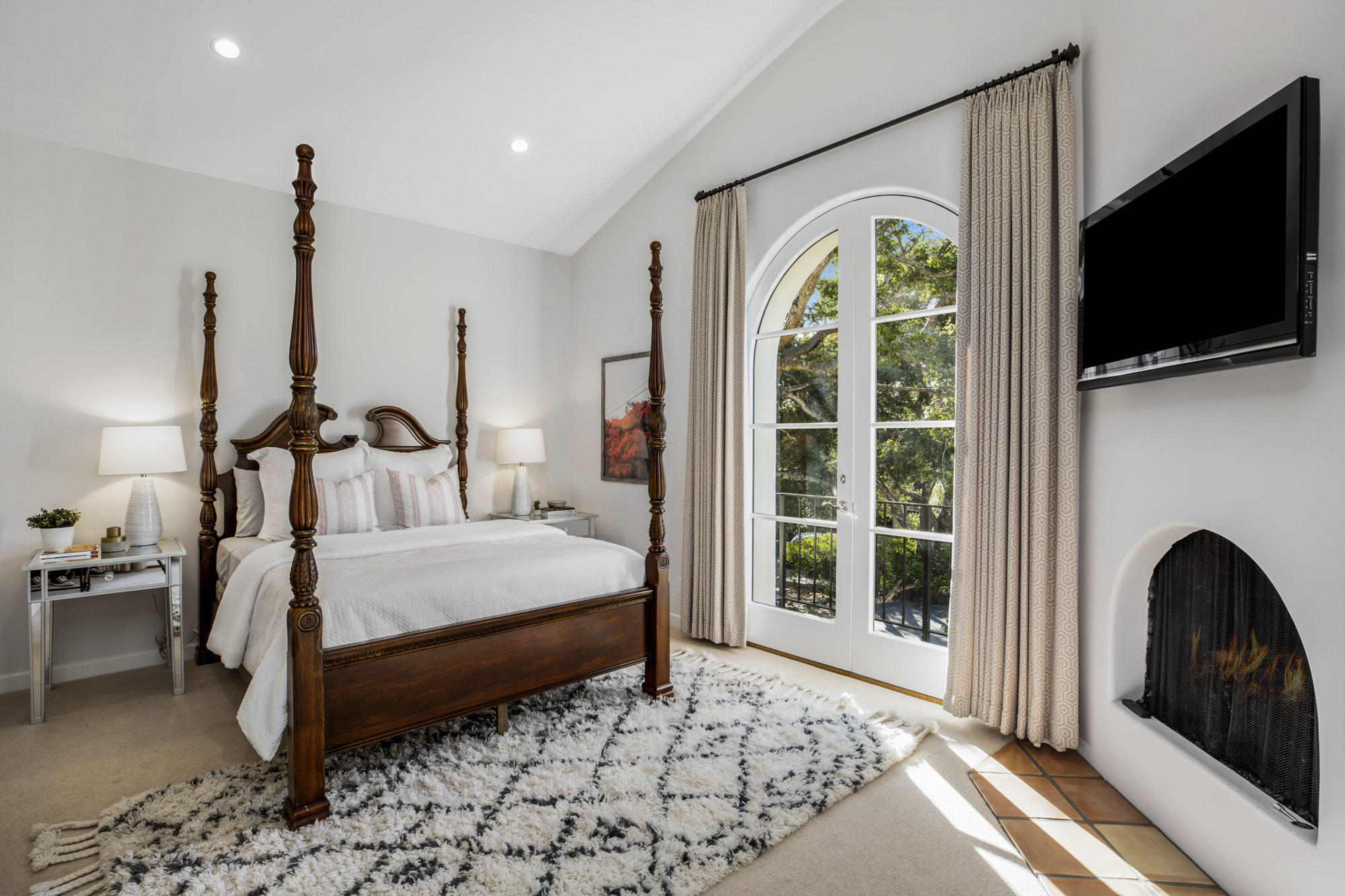 485 Monarch Lane Santa Barbara, CA 93108 - Photo 16 of 24 a bedroom with a bed a flat screen tv and a large window with the garden view