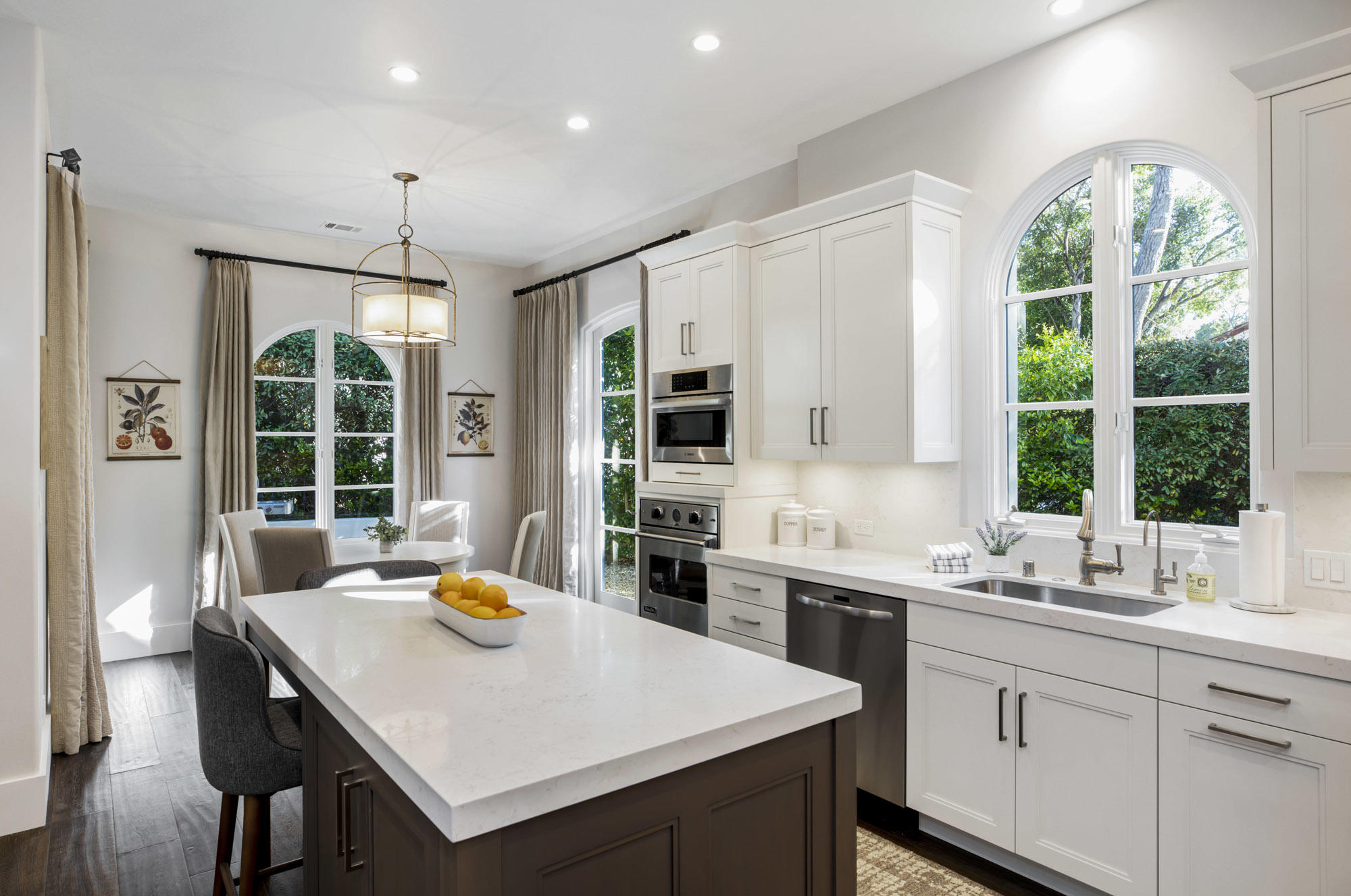 485 Monarch Lane Santa Barbara, CA 93108 - Photo 8 of 24 a kitchen with a stove a sink a kitchen island a table and chairs