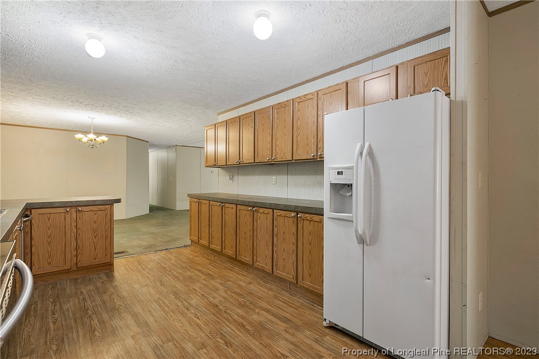 4759 Darroch Road Lillington, NC 27546 - Photo 19 of 50 a kitchen with stainless steel appliances a refrigerator and a stove top oven