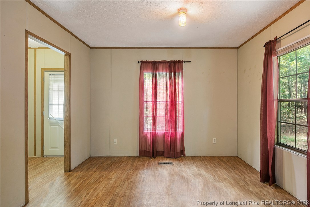 4759 Darroch Road Lillington, NC 27546 - Photo 20 of 50 an empty room with wooden floor and windows