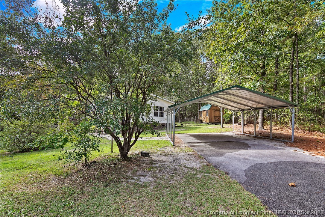 4759 Darroch Road Lillington, NC 27546 - Photo 3 of 50 a yellow house in middle of the forest