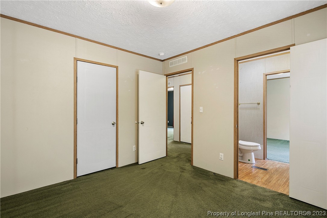 4759 Darroch Road Lillington, NC 27546 - Photo 40 of 50 a view of a hallway with closet and wooden floor