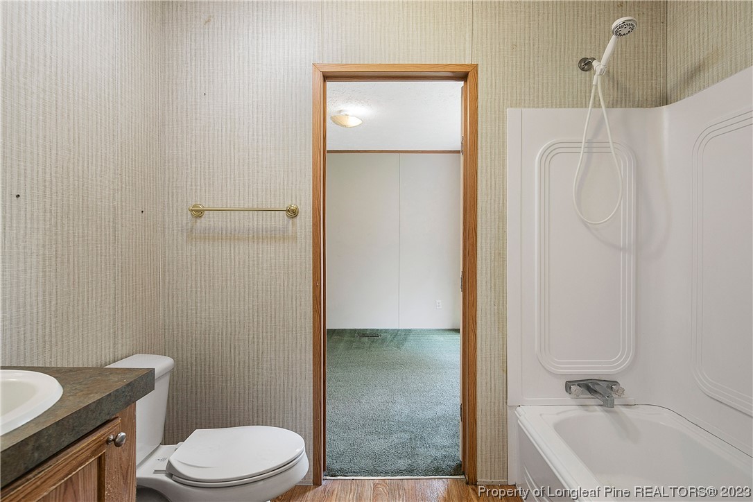 4759 Darroch Road Lillington, NC 27546 - Photo 42 of 50 a bathroom with a sink a toilet and shower