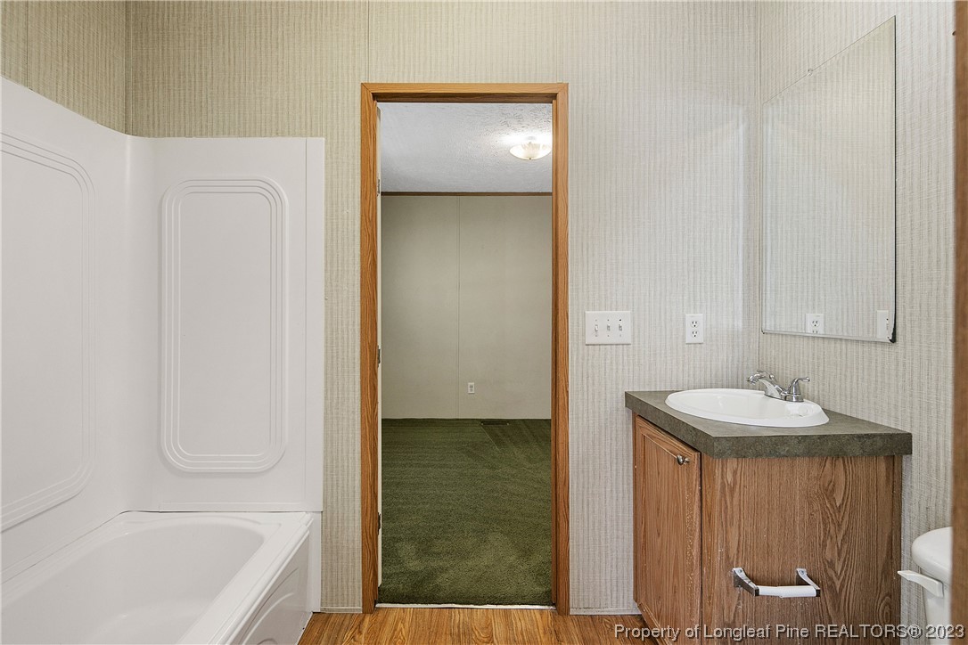 4759 Darroch Road Lillington, NC 27546 - Photo 46 of 50 a bathroom with a sink and a mirror