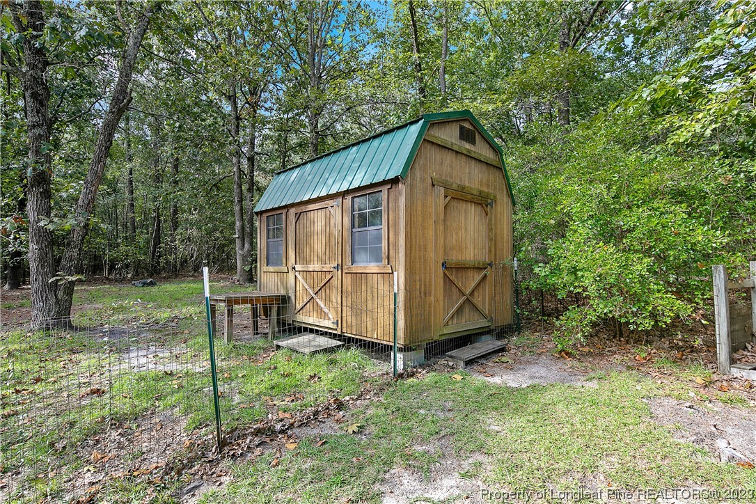 4759 Darroch Road Lillington, NC 27546 - Photo 50 of 50 a view of backyard with a barn and a large tree
