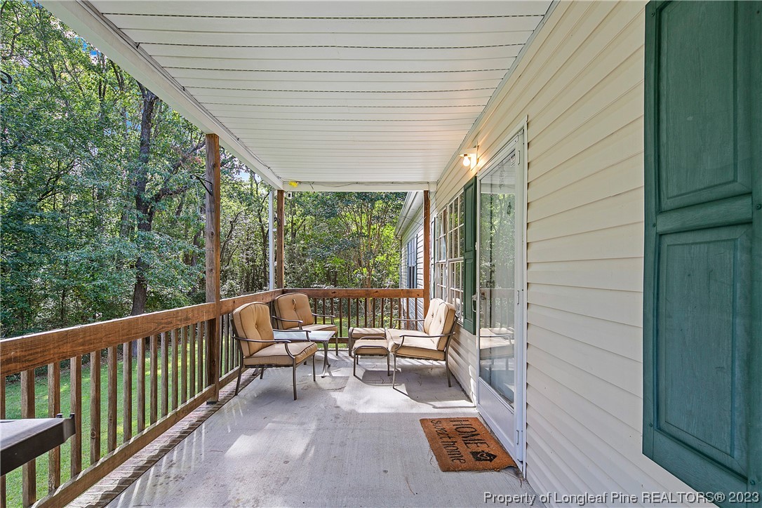 4759 Darroch Road Lillington, NC 27546 - Photo 5 of 50 a balcony with chairs and with wooden fence