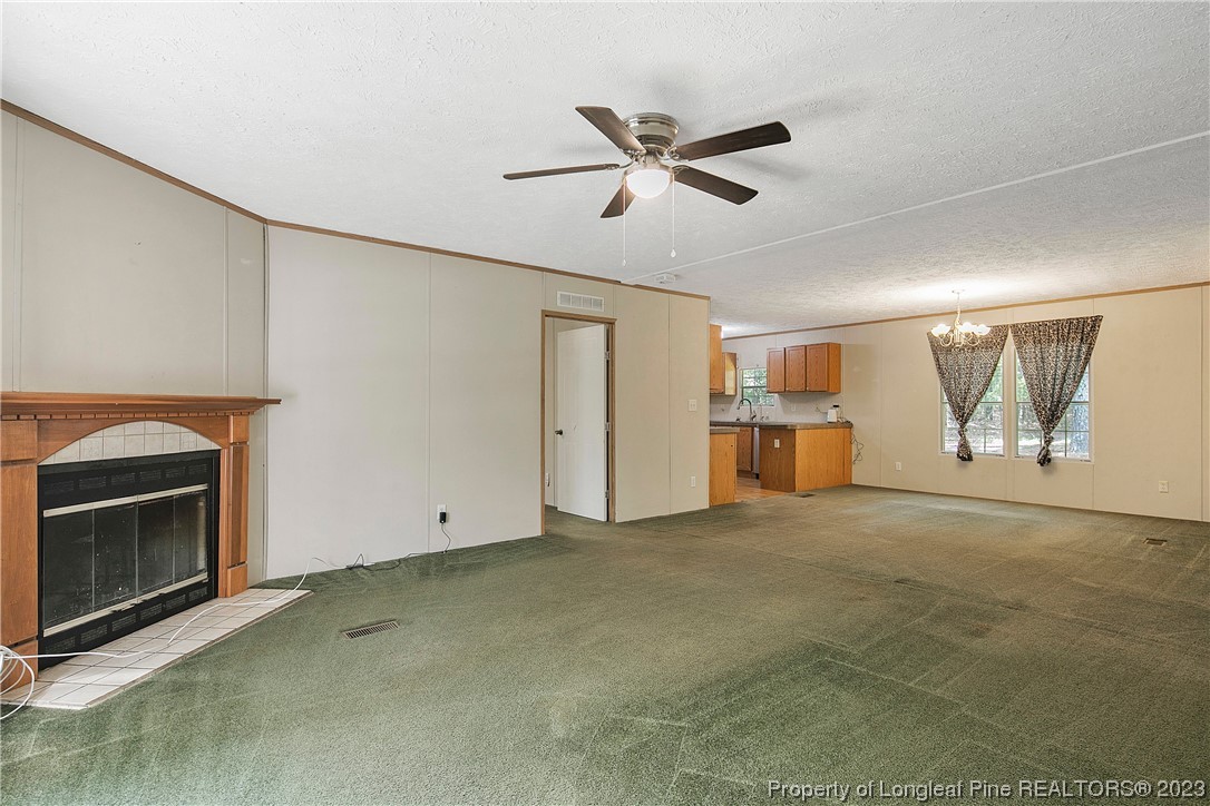 4759 Darroch Road Lillington, NC 27546 - Photo 7 of 50 a view of empty room with window and fireplace