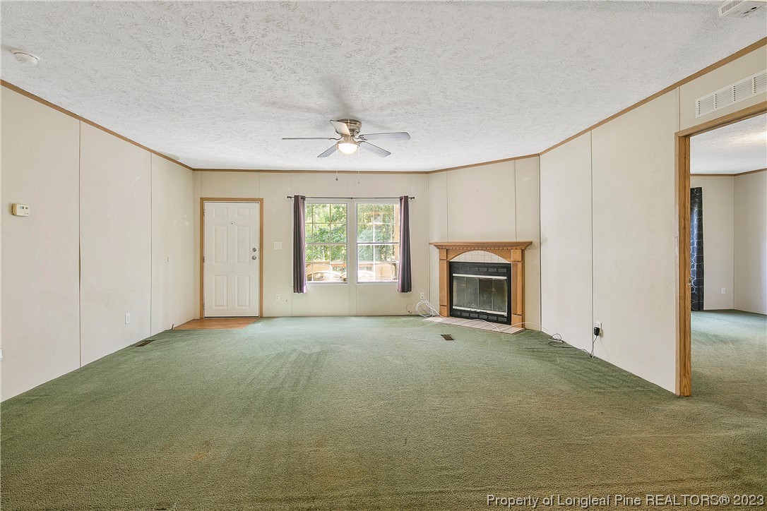 4759 Darroch Road Lillington, NC 27546 - Photo 9 of 50 a view of empty room with window and fireplace