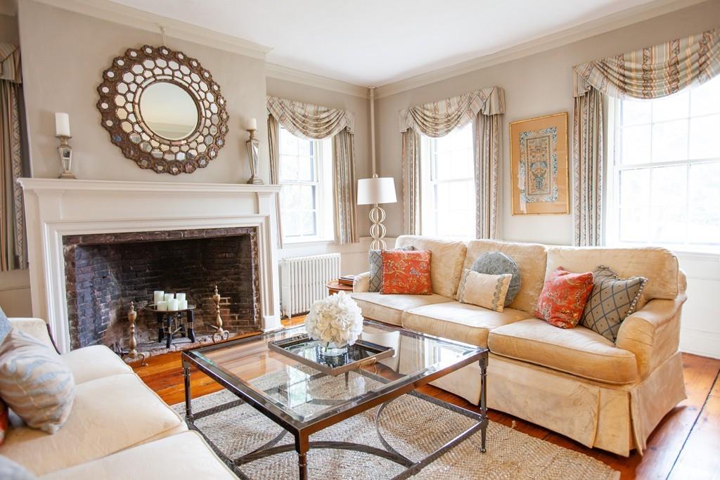 651 Boston Post Road Weston, MA 02493 - Photo 2 of 19 a living room with furniture a fireplace a window and a table
