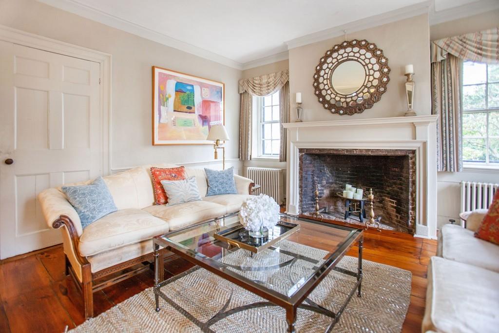 651 Boston Post Road Weston, MA 02493 - Photo 3 of 19 a living room with furniture a clock and a fireplace