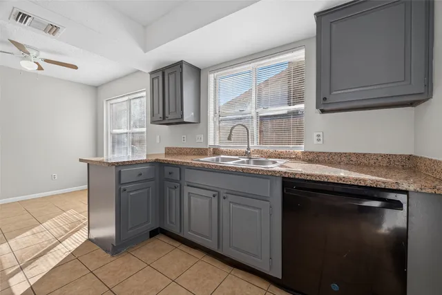 a kitchen with stainless steel appliances granite countertop a stove a sink dishwasher and a refrigerator