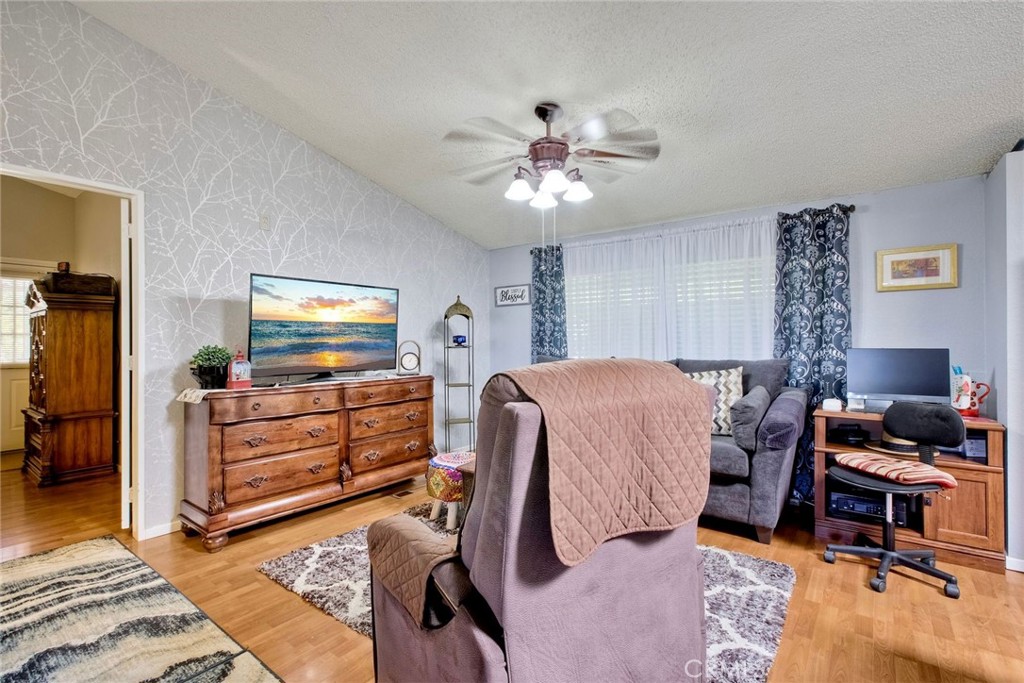 34370 The Farm Road Wildomar, CA 92595 - Photo 16 of 31 a living room with furniture and a flat screen tv
