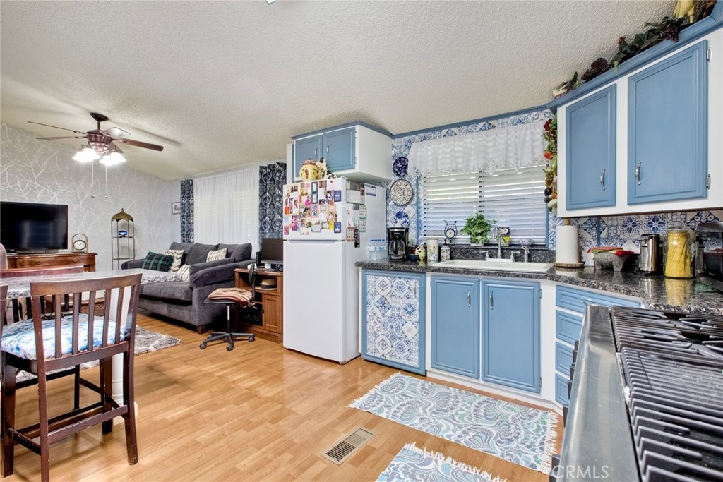 34370 The Farm Road Wildomar, CA 92595 - Photo 19 of 31 a kitchen with furniture a refrigerator and a sink