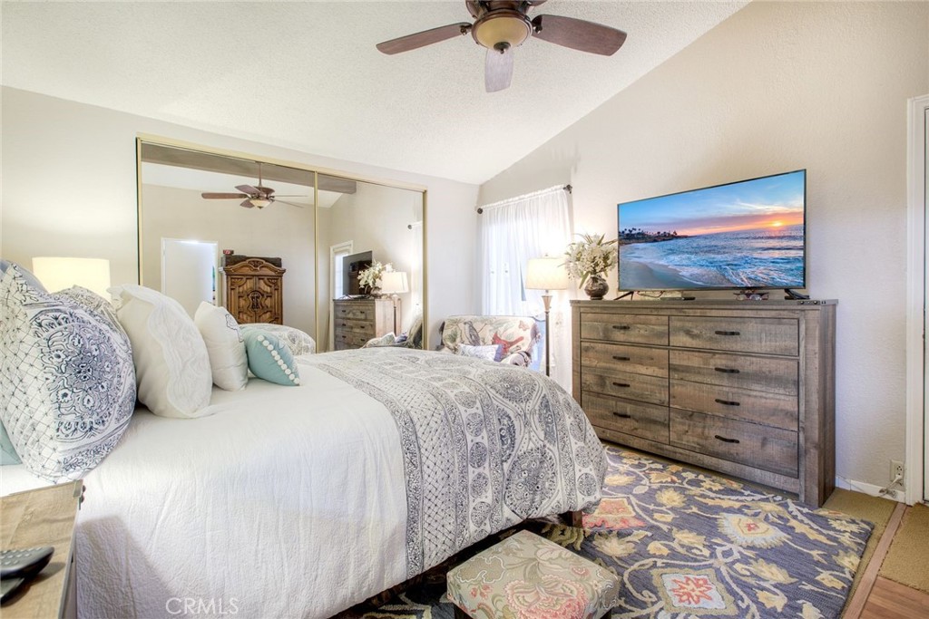 34370 The Farm Road Wildomar, CA 92595 - Photo 21 of 31 a spacious bedroom with a bed and a flat screen tv