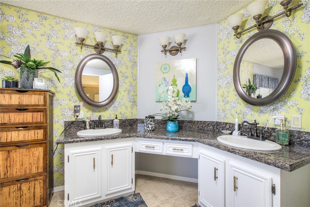 34370 The Farm Road Wildomar, CA 92595 - Photo 22 of 31 a bathroom with a granite countertop double vanity sink and a mirror