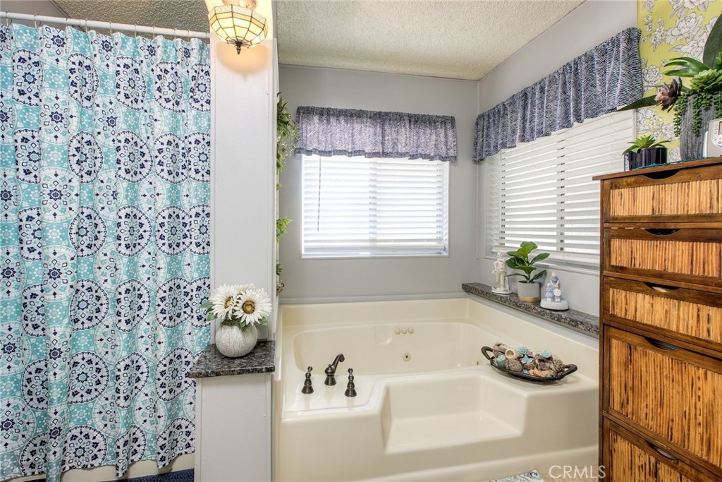 34370 The Farm Road Wildomar, CA 92595 - Photo 23 of 31 a bathroom with a bathtub sink and mirror
